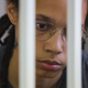 Brittney Griner, who was detained at Moscow’s Sheremetyevo airport and later charged with illegal possession of cannabis, waits for the verdict inside a defendants’ cage before a court hearing in Khimki outside Moscow, on August 4, 2022. (Photo by EVGENIA NOVOZHENINA / POOL / AFP) (Photo by EVGENIA NOVOZHENINA/POOL/AFP via Getty Images)